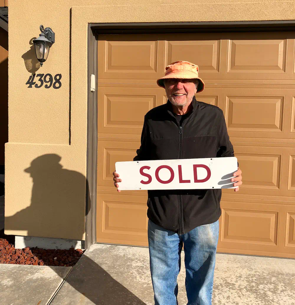 Happy client with a sold sign in front of his dream home in Meridian next to the pickleball courts.