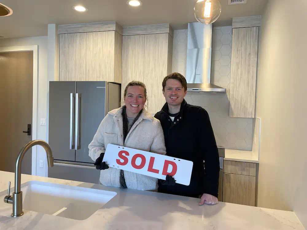 Happy Buyers standing in their crisp modern kitchen of their brand new home in Meridian.